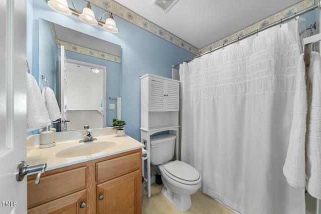 bathroom featuring visible vents, vanity, and toilet