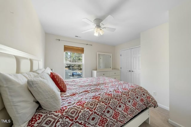 bedroom with visible vents, baseboards, a ceiling fan, carpet flooring, and a closet