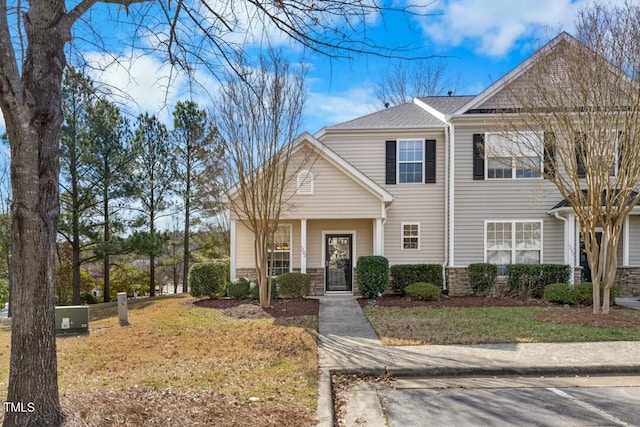 view of front of property featuring a shingled roof