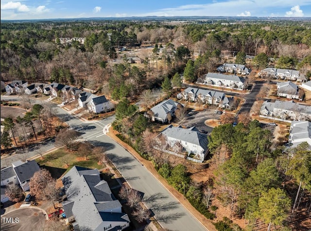 drone / aerial view with a residential view and a view of trees