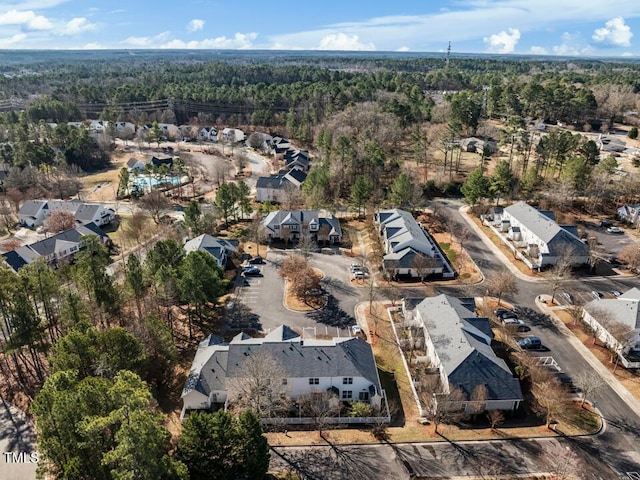 birds eye view of property featuring a wooded view and a residential view