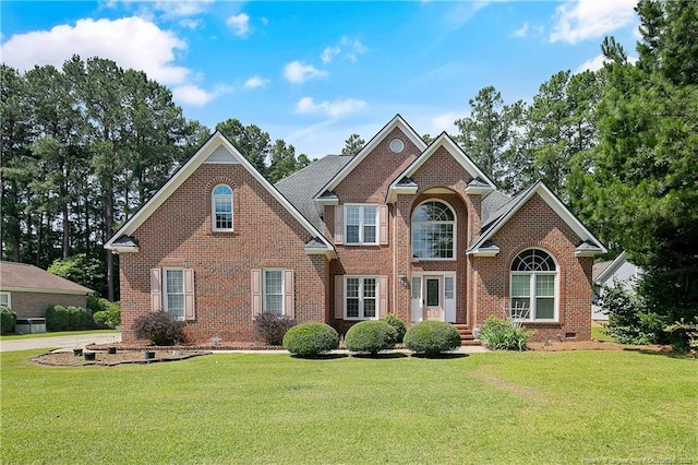 view of front of house featuring a front lawn and brick siding