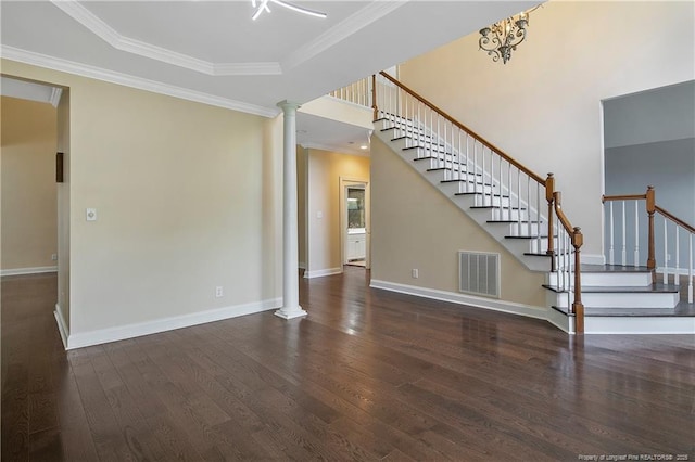 unfurnished living room with decorative columns, visible vents, wood finished floors, and ornamental molding