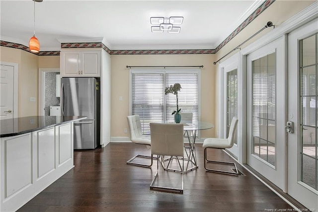 dining area featuring baseboards, dark wood finished floors, and crown molding