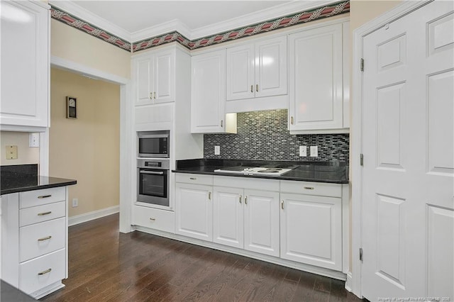 kitchen with dark wood-style floors, stainless steel appliances, ornamental molding, and dark countertops