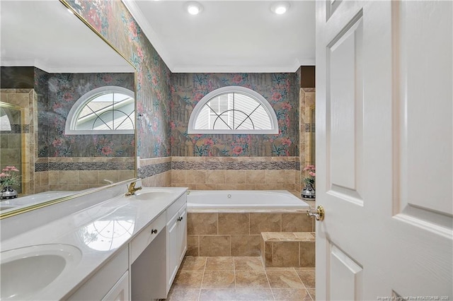 bathroom featuring double vanity, a garden tub, a sink, and wallpapered walls