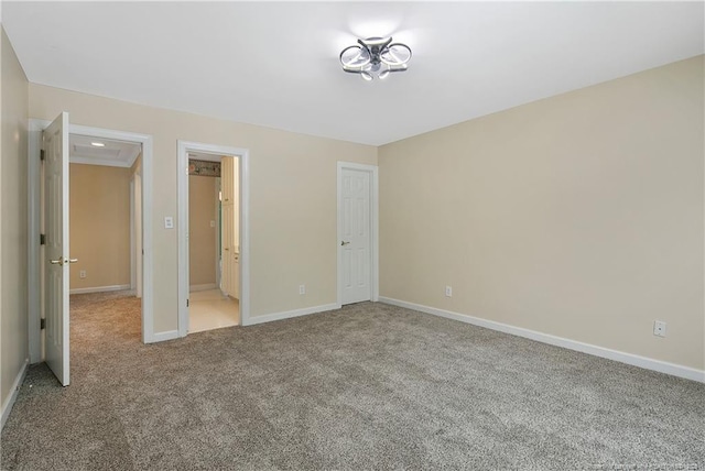 unfurnished bedroom with carpet floors and baseboards