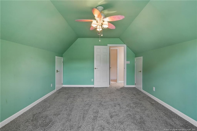 additional living space with lofted ceiling, carpet floors, baseboards, and a ceiling fan