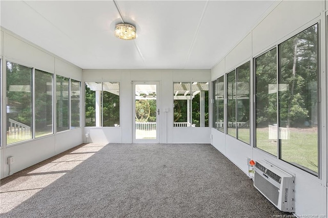 unfurnished sunroom featuring a wall mounted AC