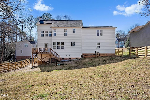 back of house featuring stairs, a chimney, a fenced backyard, a yard, and crawl space