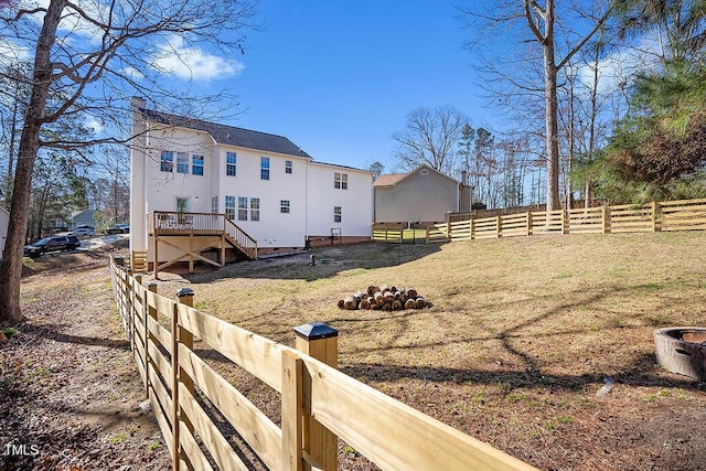 exterior space featuring a fire pit, a deck, stairs, and fence