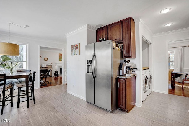 kitchen with washing machine and clothes dryer, baseboards, crown molding, and stainless steel refrigerator with ice dispenser