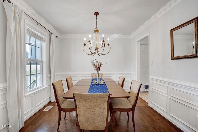 dining area with a chandelier, dark wood-style floors, a healthy amount of sunlight, and crown molding