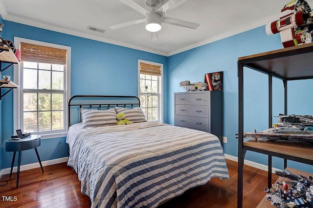 bedroom with visible vents, crown molding, baseboards, and wood-type flooring