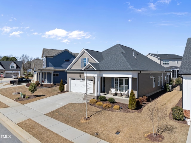 view of front of property with a shingled roof, a residential view, concrete driveway, and covered porch