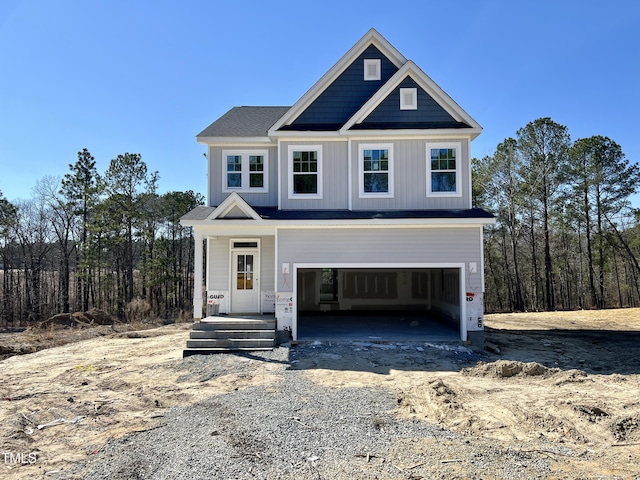 view of front of house with a garage, driveway, and board and batten siding