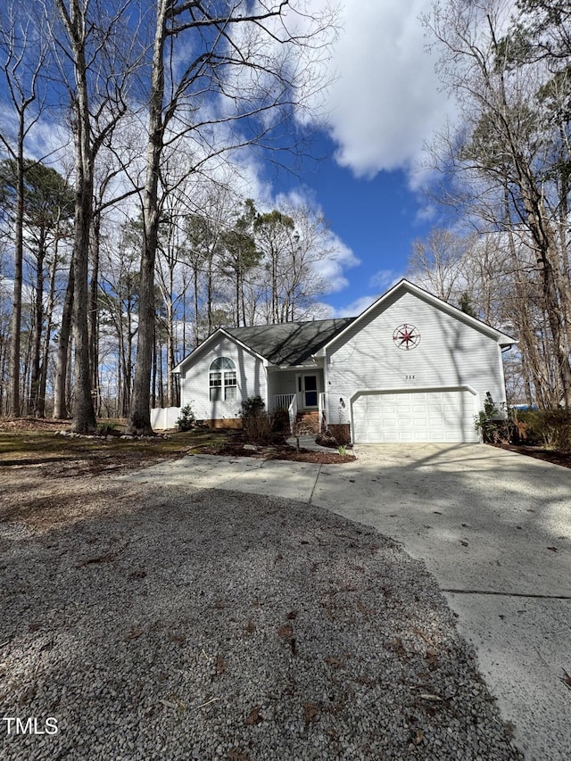 view of front facade featuring driveway, an attached garage, and brick siding