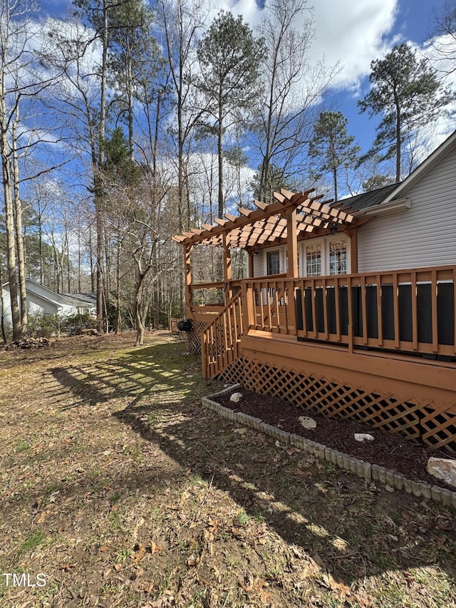 view of yard featuring a wooden deck and a pergola