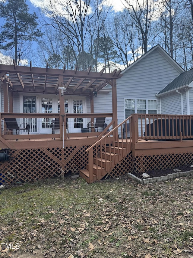 rear view of property with a deck and a pergola