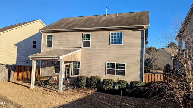 rear view of property with a patio area and fence