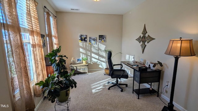 carpeted home office with visible vents and baseboards