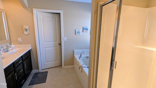 full bathroom featuring a garden tub, vanity, baseboards, a shower stall, and tile patterned floors