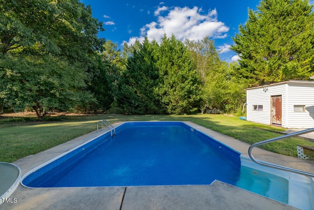 outdoor pool with a lawn and an outdoor structure