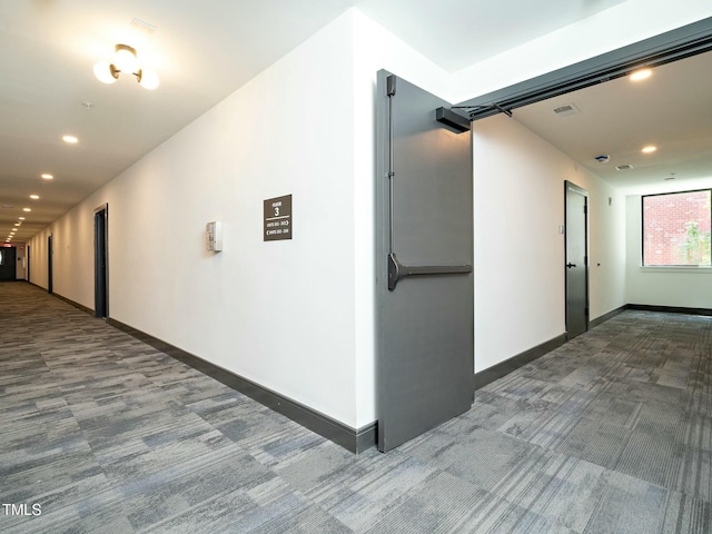 hallway featuring carpet floors, recessed lighting, visible vents, and baseboards