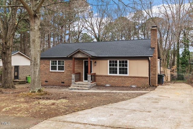 view of front of home featuring crawl space, a shingled roof, a chimney, and brick siding