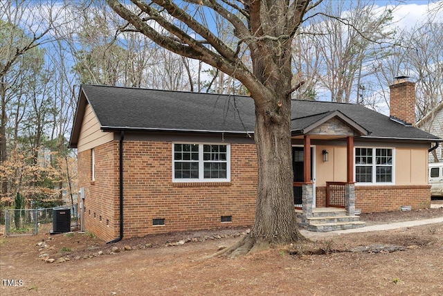 view of front of house featuring a chimney, roof with shingles, crawl space, fence, and brick siding