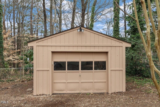 garage with a shed and fence