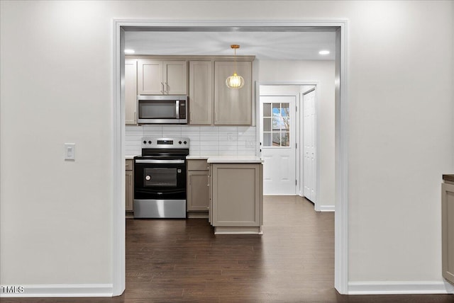 kitchen with baseboards, decorative backsplash, dark wood-style floors, appliances with stainless steel finishes, and light countertops