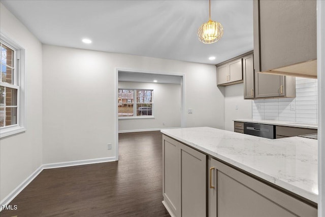 kitchen with gray cabinetry, baseboards, light stone countertops, tasteful backsplash, and dark wood finished floors