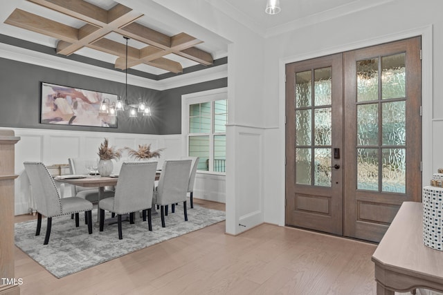 dining area with a wealth of natural light, french doors, wood finished floors, and beam ceiling