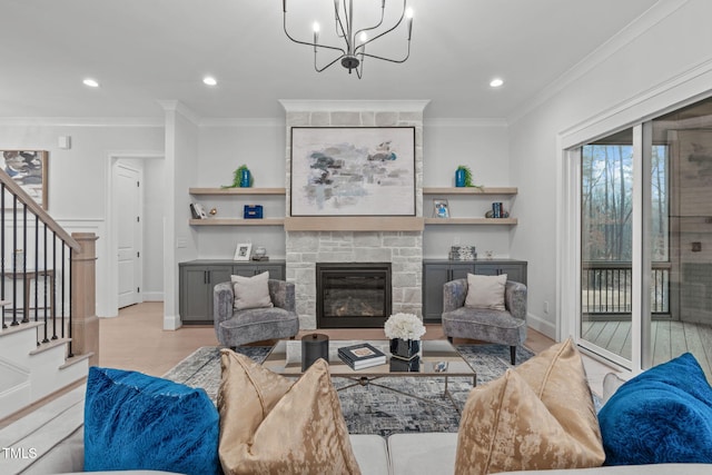 living room with crown molding, a fireplace, recessed lighting, stairway, and light wood-type flooring