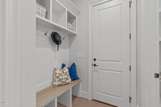 mudroom featuring light wood-style floors and baseboards