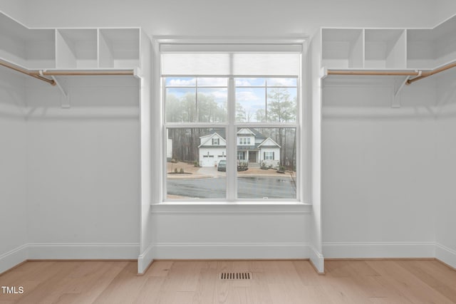 walk in closet featuring visible vents and wood finished floors