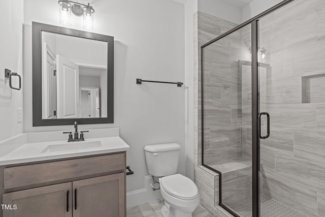 full bath featuring a stall shower, baseboards, vanity, and toilet