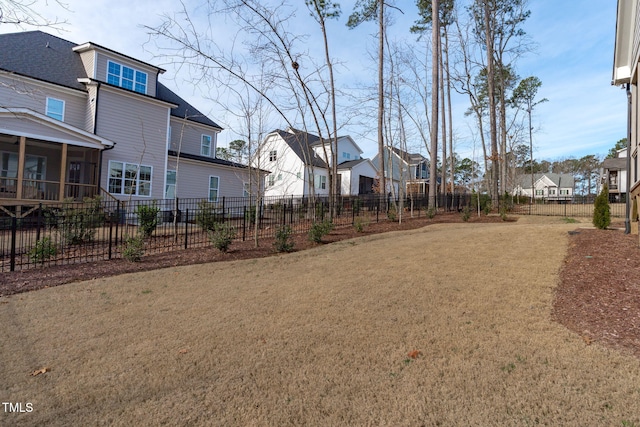 view of yard with a residential view and fence