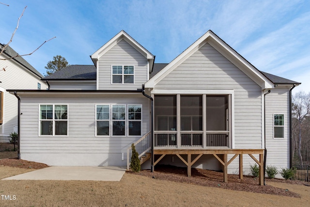 back of property featuring a sunroom, fence, and a patio