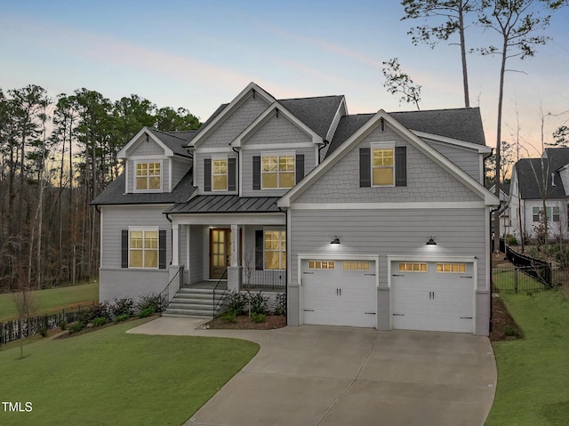 view of front of property featuring covered porch, concrete driveway, a lawn, an attached garage, and fence