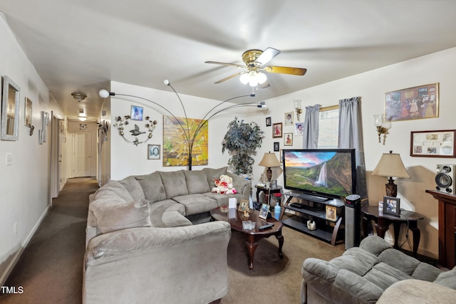 living room featuring carpet floors, baseboards, and a ceiling fan