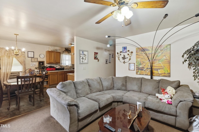 living area with light carpet and ceiling fan with notable chandelier