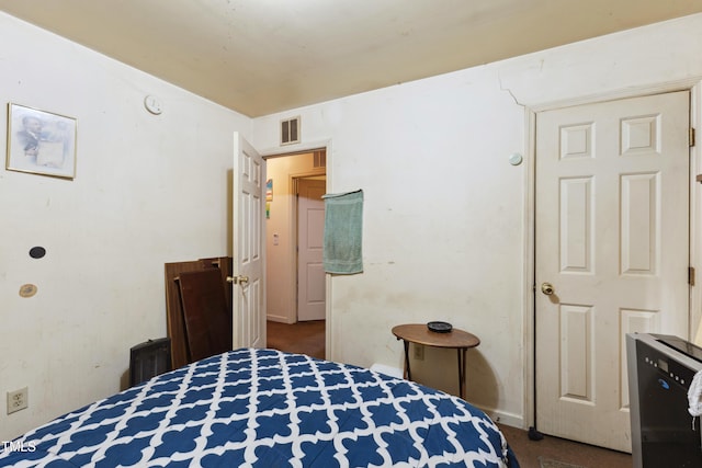 bedroom featuring baseboards and visible vents