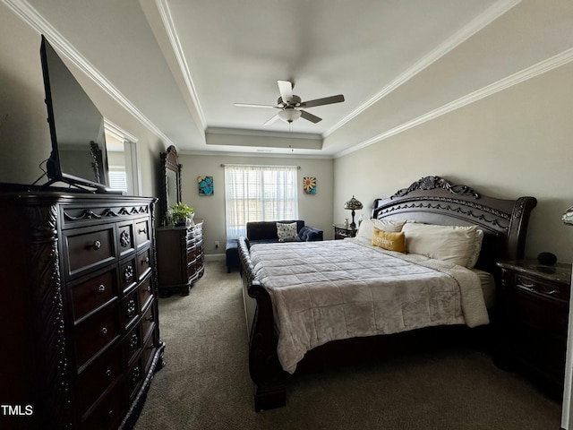 bedroom with ceiling fan, a tray ceiling, carpet, and crown molding