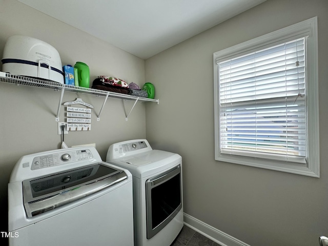 washroom featuring baseboards, laundry area, and washer and dryer