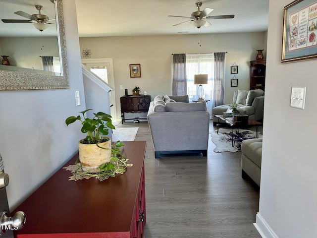 living room featuring ceiling fan and wood finished floors