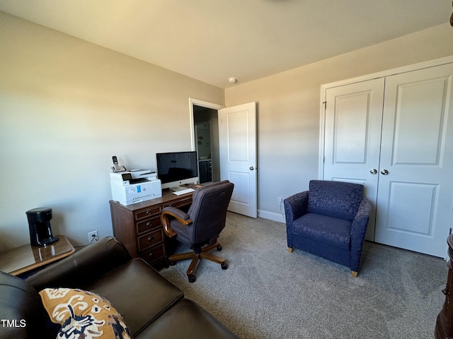 carpeted office featuring baseboards