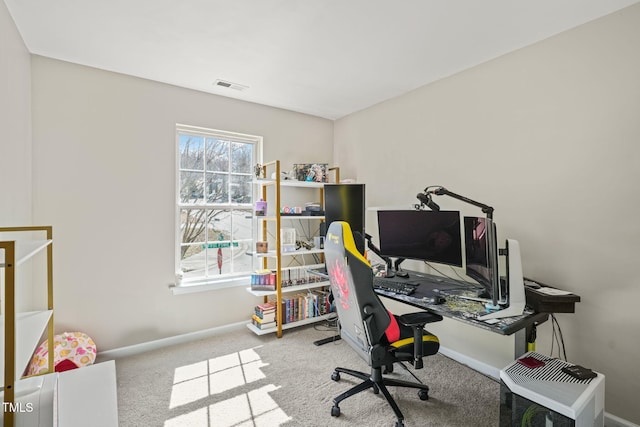 carpeted office featuring visible vents and baseboards