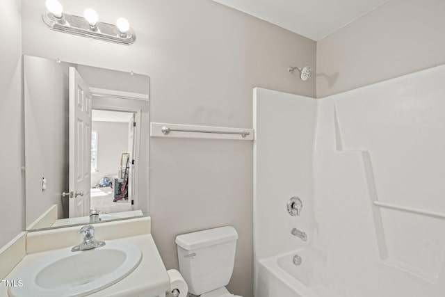 bathroom featuring tub / shower combination, vanity, and toilet